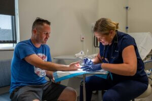 man getting suture from nurse